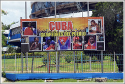 Billboard in front of the Coliseo de la Ciudad Deportiva sporting arena: "Cuba campeones del pueblo" ("champions of the people").