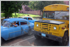 Blue cars and a repurposed school bus (now carrying adult passengers), corner of Calle Avenida de M&eacute;xico Cristina and Calzada 10 de Octubre.