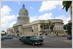 Green cars in front of El Capitolio.