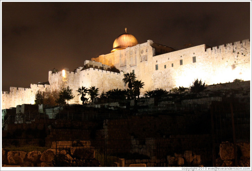 Night view of a dome and walls of the Old City of Jerusalem.