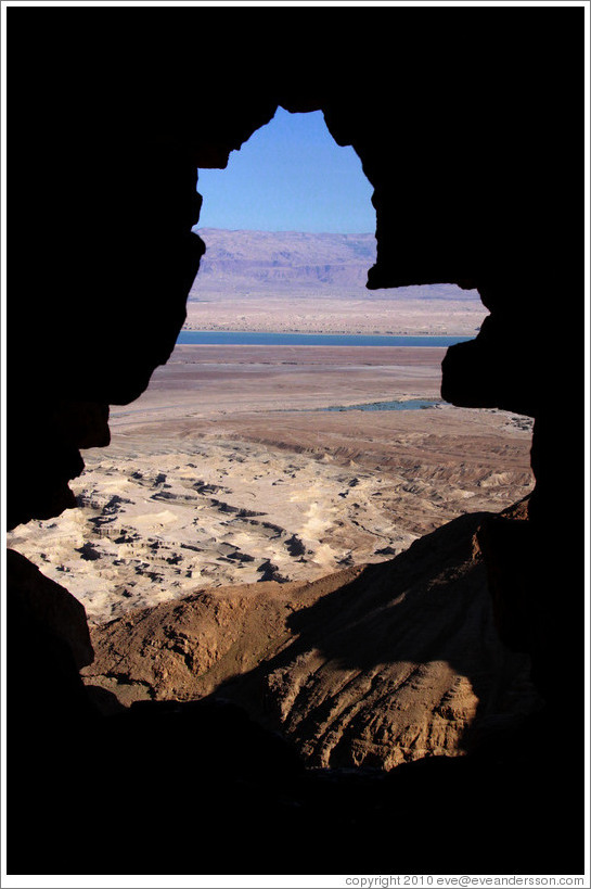 View of the desert and dead sea through a hole in the South Gate, desert fortress of Masada.