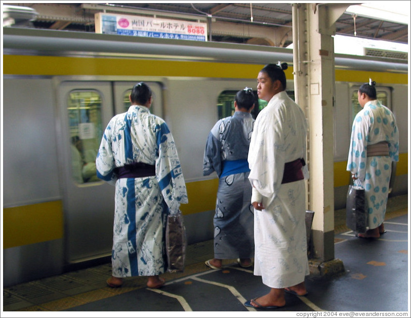 Sumo wrestlers waiting for the JR train.