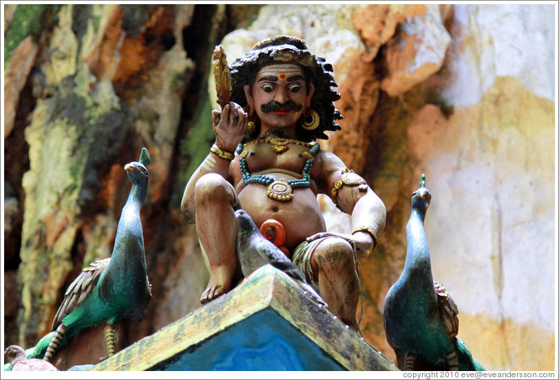 Male figure with peacocks, roof of temple, 2nd level, Batu Caves.