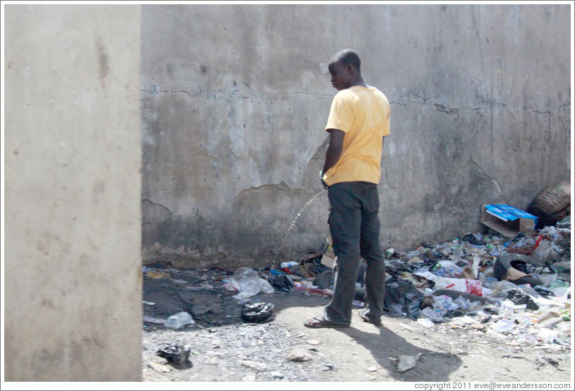 Man urinating. Lagos Island.