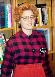 nerdy female with orange shorts and plaid red shirt