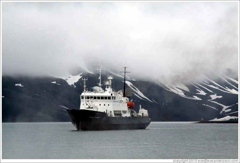 Polar Pioneer in front of the cloud-shrouded mountains of Deception Island.