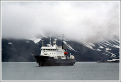 Polar Pioneer in front of the cloud-shrouded mountains of Deception Island.