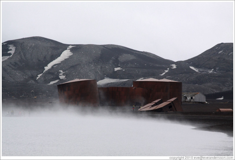 Large tanks used for diesel fuel and whale oil, shrouded by steam from geothermal water, Whaler's Bay.