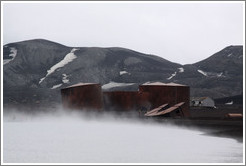 Large tanks used for diesel fuel and whale oil, shrouded by steam from geothermal water, Whaler's Bay.