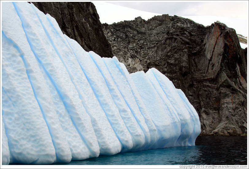 Blue iceberg and granite rocks.