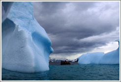 Zodiac among blue icebergs.