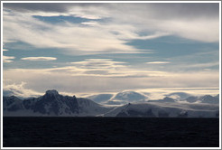 Lenticular clouds hovering over mountains on the west coast of Graham Land.