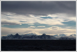 Lenticular clouds hovering over mountains on the west coast of Graham Land.