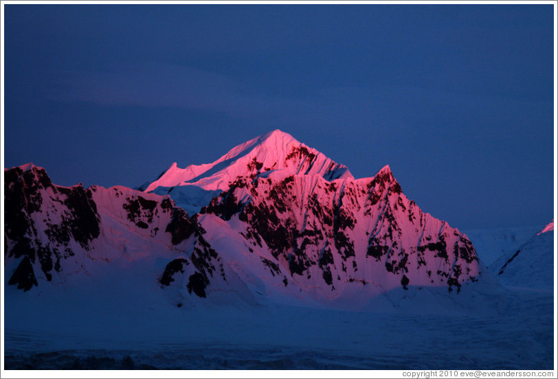 Sunset reflecting off a snowy mountain.