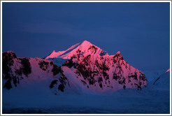 Sunset reflecting off a snowy mountain.