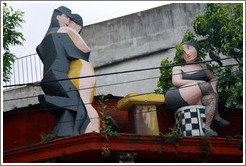 Sculptures on the roof of a building, depicting tango dancers and a longing spectator. Gral. Gregorio Ar? de Lamadrid, La Boca.