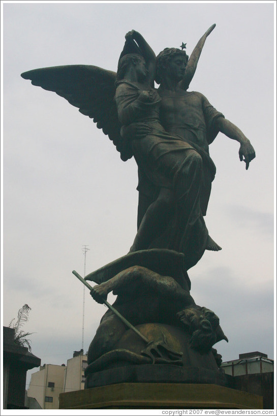 La Recoleta Cemetery.  Statue of an angel, a child, and a devil.