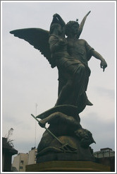 La Recoleta Cemetery.  Statue of an angel, a child, and a devil.