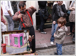 Boy watching a pupeteer. Sunday market, Calle Defensa, San Telmo.