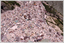 Natural stones of many colors embedded in a hillside.