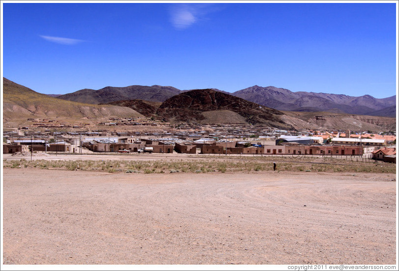 Buildings with mountains behind.