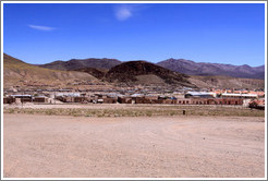 Buildings with mountains behind.