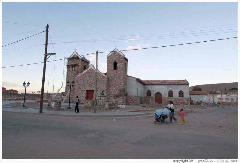 Church with a family walking by.