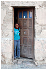 Girl in a doorway.