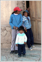 Three kids in a doorway.