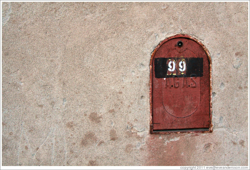 Mailbox embedded in a concrete wall.
