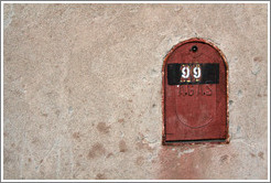 Mailbox embedded in a concrete wall.