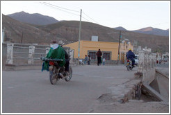 Motorcyclists crossing a bridge.