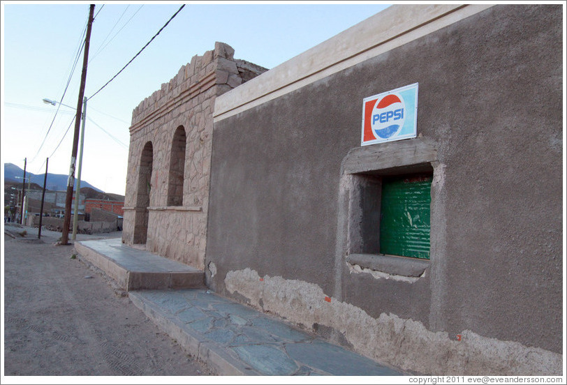 Window with Pepsi sign.