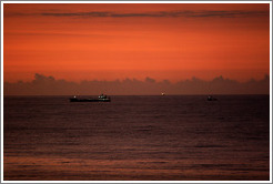 Boat seen from Ipanema at sunrise.