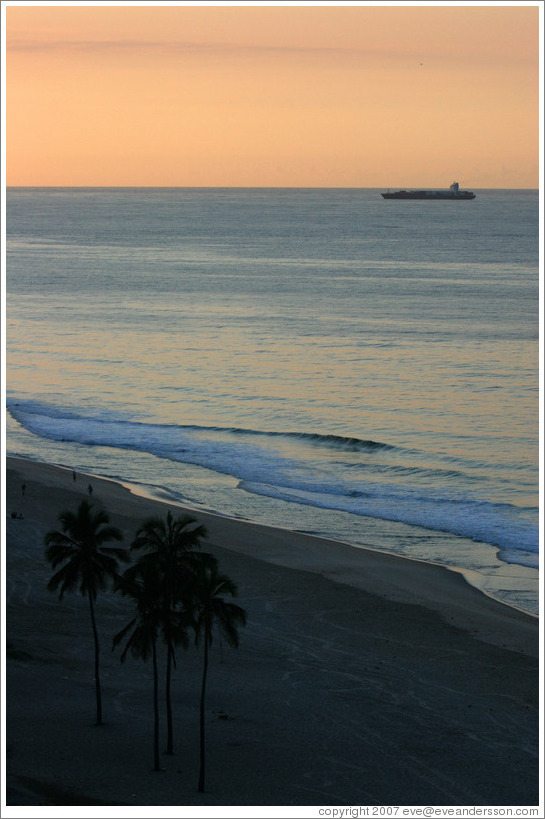 Ipanema Beach at sunrise.  Palm trees and boat.