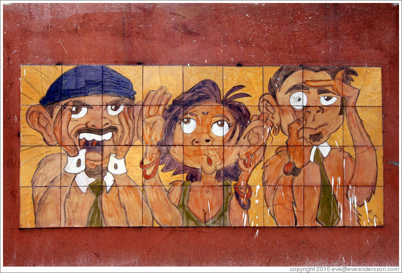 Artwork: three people.  Wall surrounding the Cemit?o S?Paulo.