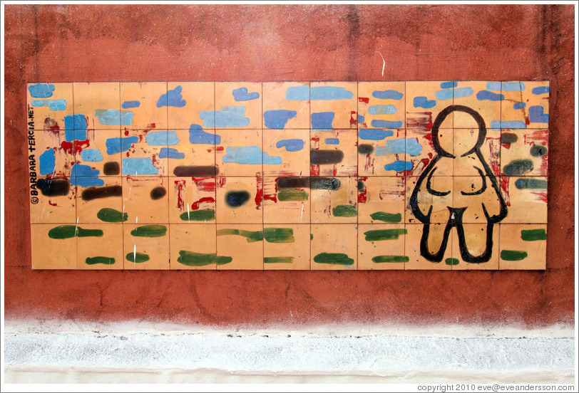 Artwork: woman with no clothes or hair.  Wall surrounding the Cemit?o S?Paulo.