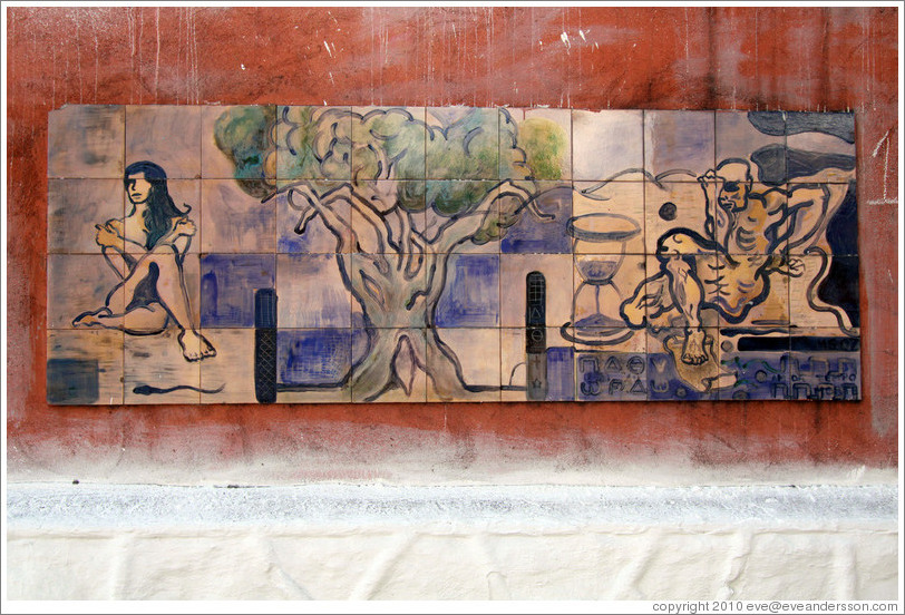 Artwork: woman, tree, hourglass, man.  Wall surrounding the Cemit?o S?Paulo.