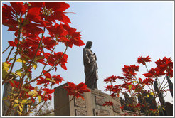 Flowers and a Jesus statue.  Cemit?o S?Paulo.