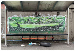 Graffiti at a bus stop: green mountains and trees.  Av. Pres. Juscelino Kubitschek at Rua Dr. Renato Paes de Barros.