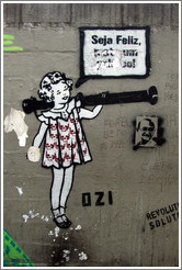 Graffiti: girl with skulls on her dress saying "Seja Feliz".  Created by graffiti artist Ozi.  Av. Brg. Lu?Ant? at Pra?Dom Gast?Liberal Pinto.