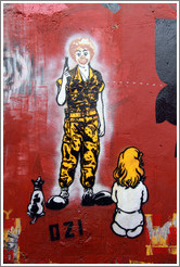 Graffiti: Ronald McDonald with a gun, with a dog and girl sitting in front of him.  Created by graffiti artist Ozi.  Villa Magdalenda neighborhood.  Alley between Rua Padre Jo?Gon?ves and
Rua Belmiro Braga.