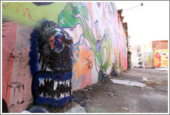Graffiti: blue protusion with teeth.  Villa Magdalenda neighborhood.  Alley between Rua Padre Jo?Gon?ves and Rua Belmiro Braga.