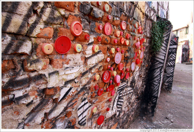 Lids attached to a wall.  Alley between Rua Padre Jo?Gon?ves and Rua Belmiro Braga.