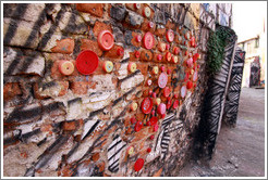 Lids attached to a wall.  Alley between Rua Padre Jo?Gon?ves and Rua Belmiro Braga.