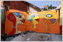 Graffiti: three heads on a yellow background.  Villa Magdalenda neighborhood.  Alley between Rua Padre Jo?Gon?ves and Rua Belmiro Braga.