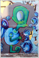 Graffiti: tired green alien with blue spheres.  Villa Magdalenda neighborhood. Alley between Rua Padre Jo?Gon?ves and Rua Belmiro Braga.