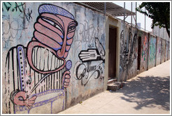 Graffiti: man with drum.  Villa Magdalenda neighborhood.  Rua Ant? Bicudo near Rua Benjamin Egas.