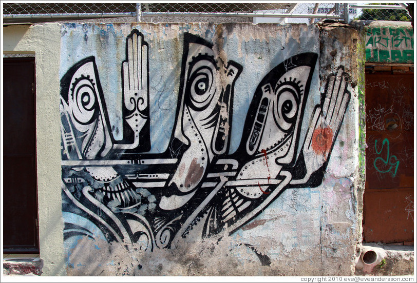 Graffiti: three black-and-white-people showing their hands.  Villa Magdalenda neighborhood.  Rua Ant? Bicudo near Rua Benjamin Egas.