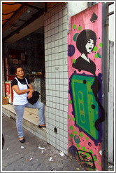 Graffiti: woman with a large, green cassette tape.  Villa Magdalenda neighborhood.  Rua Cardeal Arcoverde.